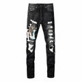 Amiri black distressed jeans front view